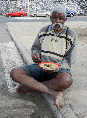 Happy local chap enjoying the traditional dish of beans and rice