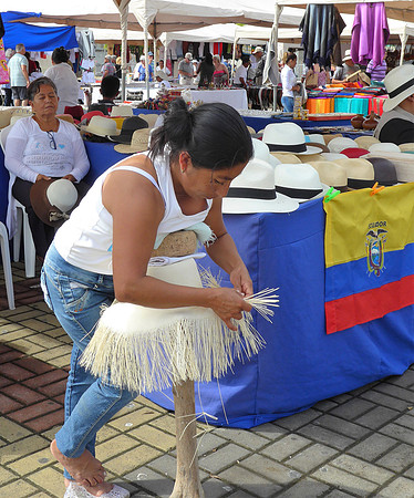 Weaving Panama hat in local market - Manta