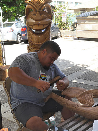 Traditional wood-carver working on new art piece in Lahaina
