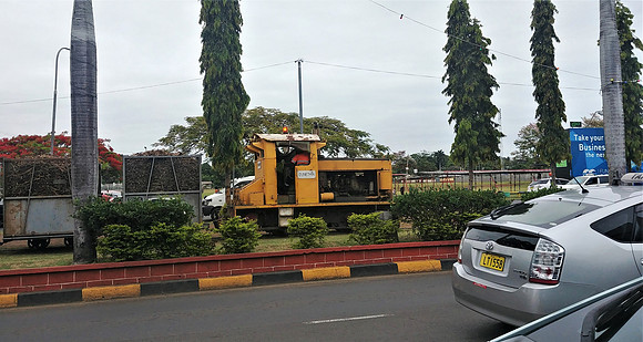 Engine pulling rail cars along main street in Lautoka, Fiji